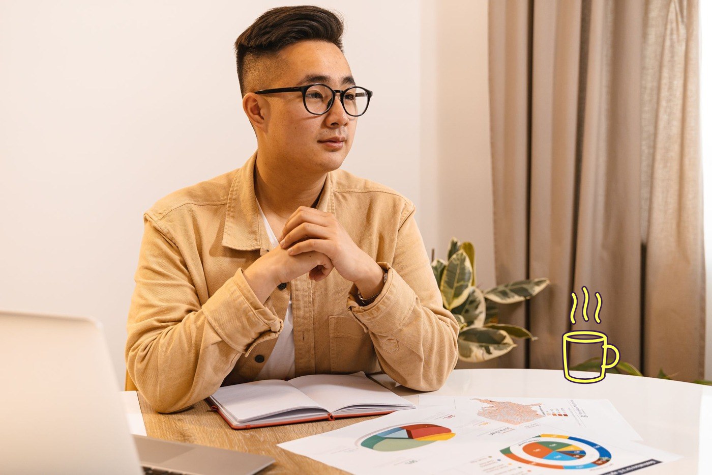 A finance lead at a round table with charts in front of him, a drawn lemon mug of coffee steaming on the table to his right