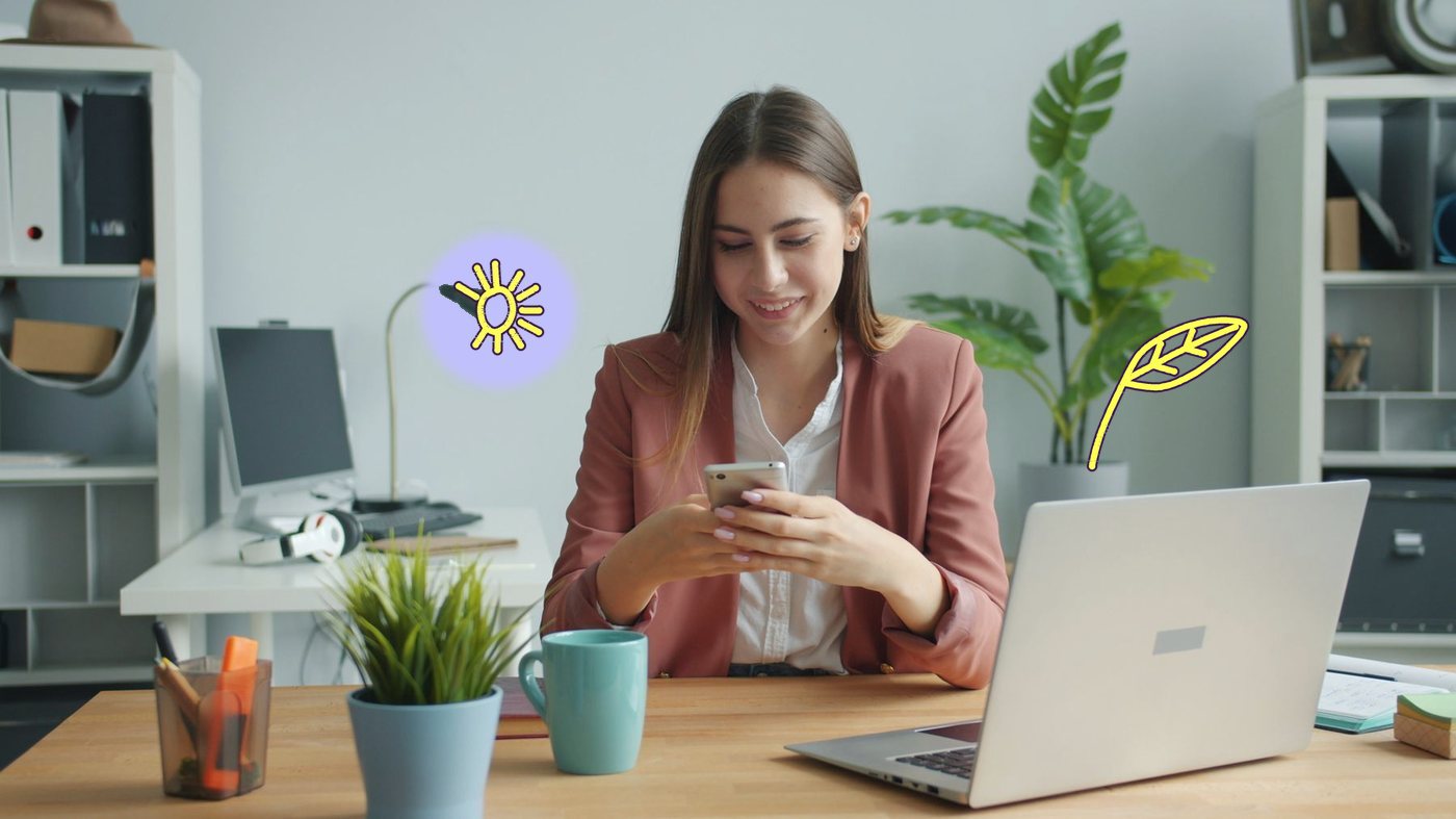 A retention marketer checking a campaign on her phone at her desk